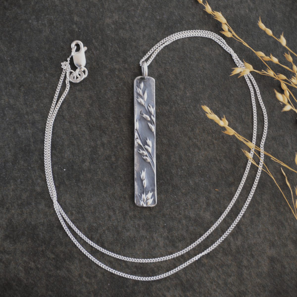A Long Silver Pendant Textured with Prairie Switchgrass - Gayle Dowell