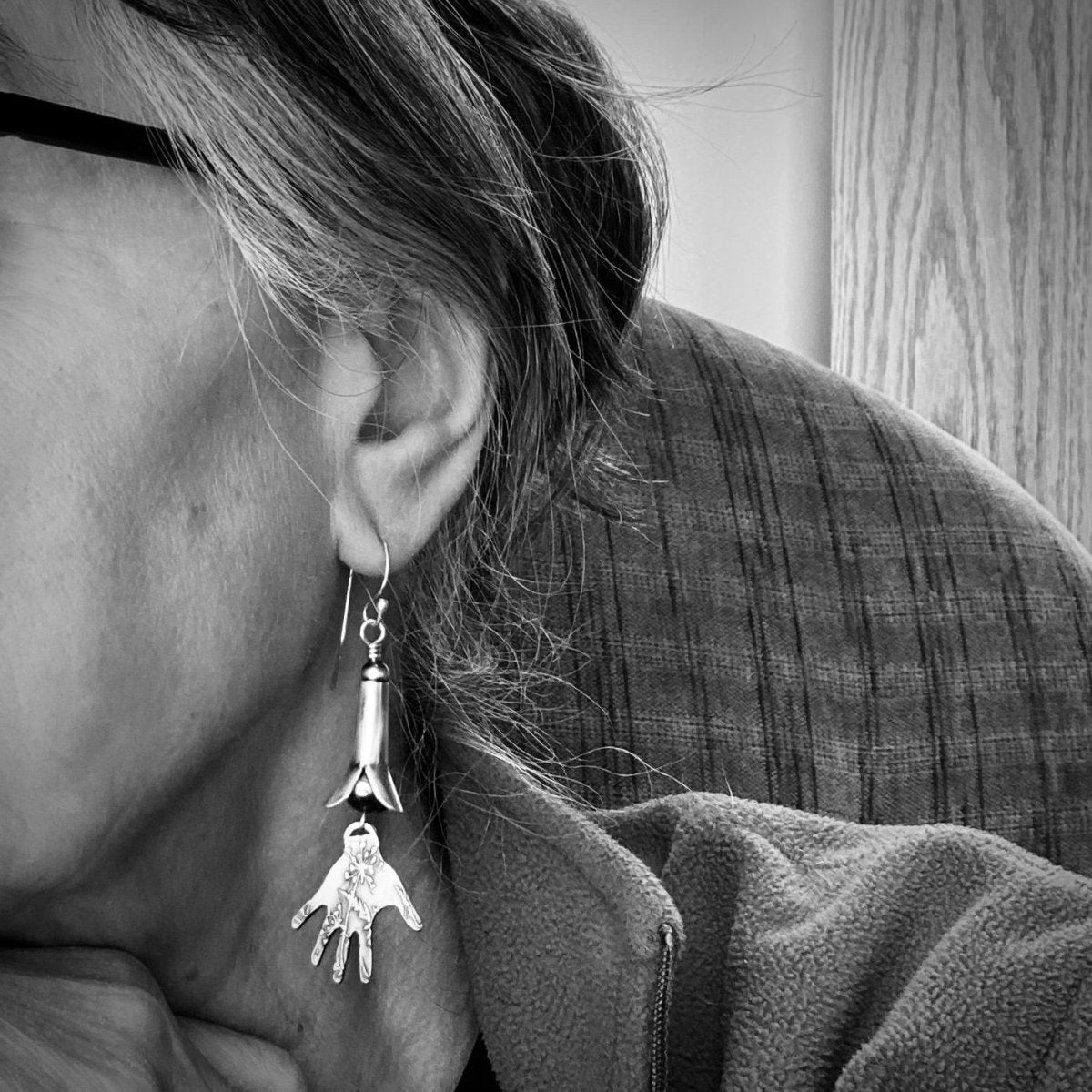 Silver Squash Blossom Earrings With Hands Textured with a Prairie Design Shown on a Person - Gayle Dowell