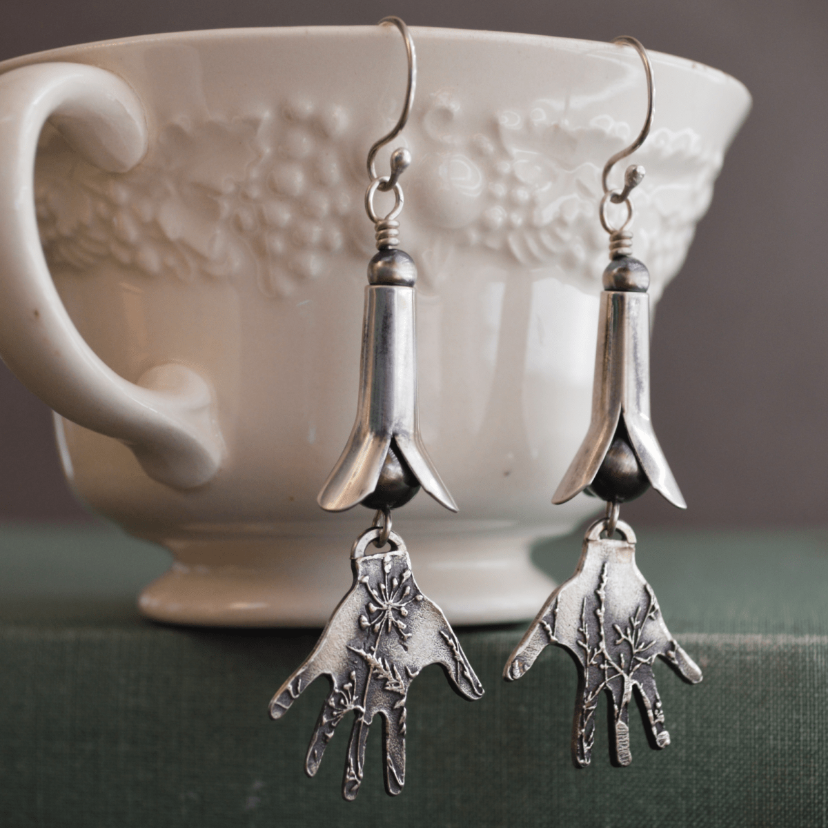 Silver Squash Blossom Earrings With Hands Textured with a Prairie Design Hanging from a Teacup- Gayle Dowell